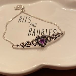 Adjustable silvertone bracelet with purple stone